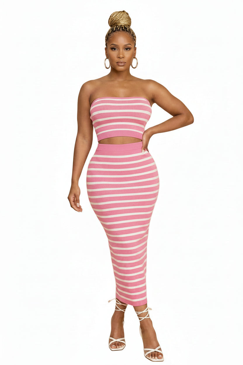 Woman wearing a pink and white striped dress on a white background