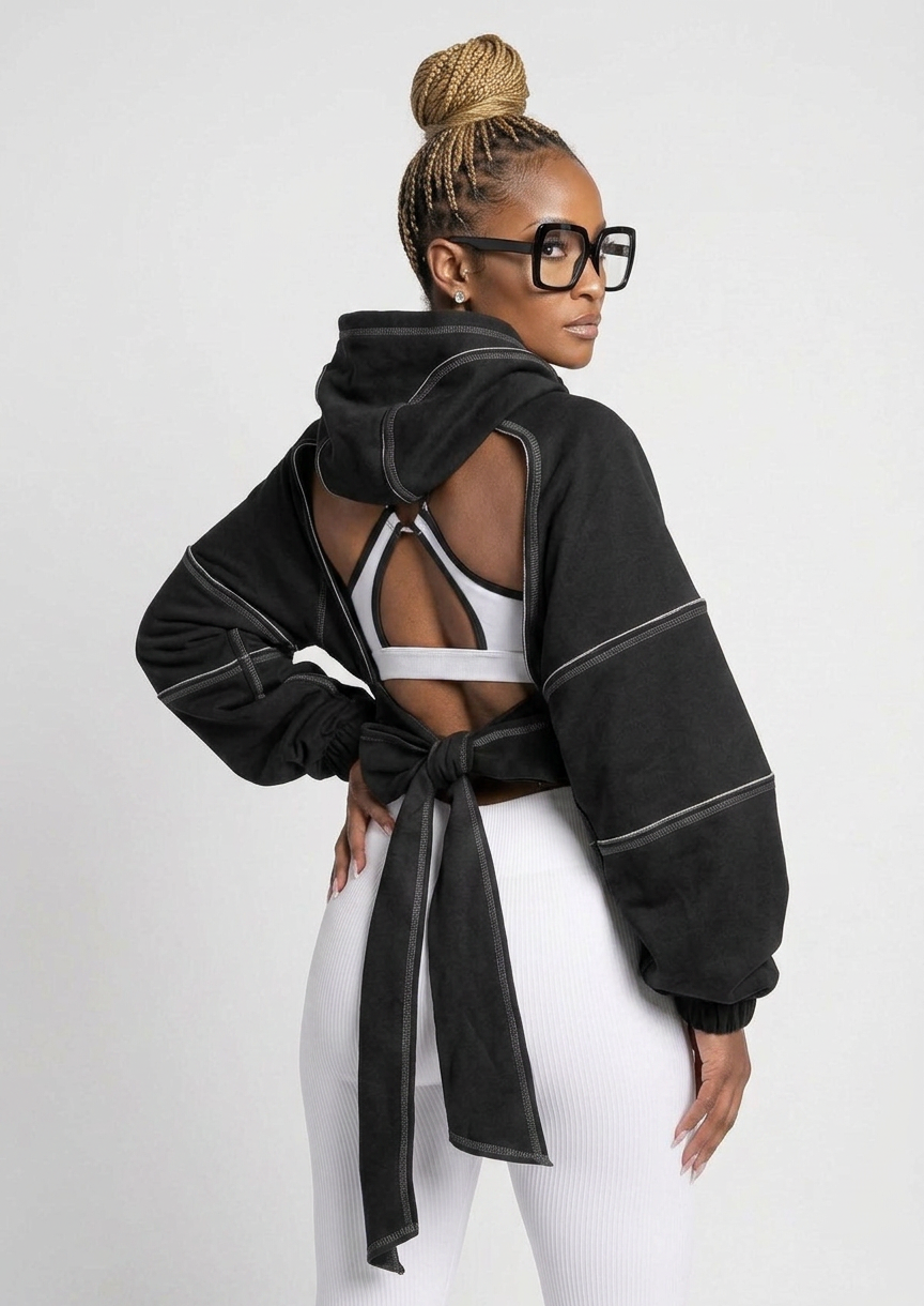 The Remix Hoodie — black deconstructed cropped hoodie with white contrast topstitching, cutout shoulders and open tie-back detail