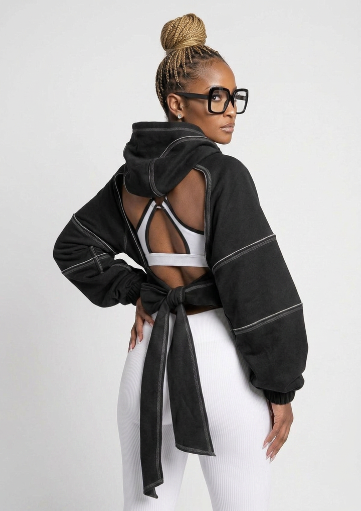 The Remix Hoodie — black deconstructed cropped hoodie with white contrast topstitching, cutout shoulders and open tie-back detail